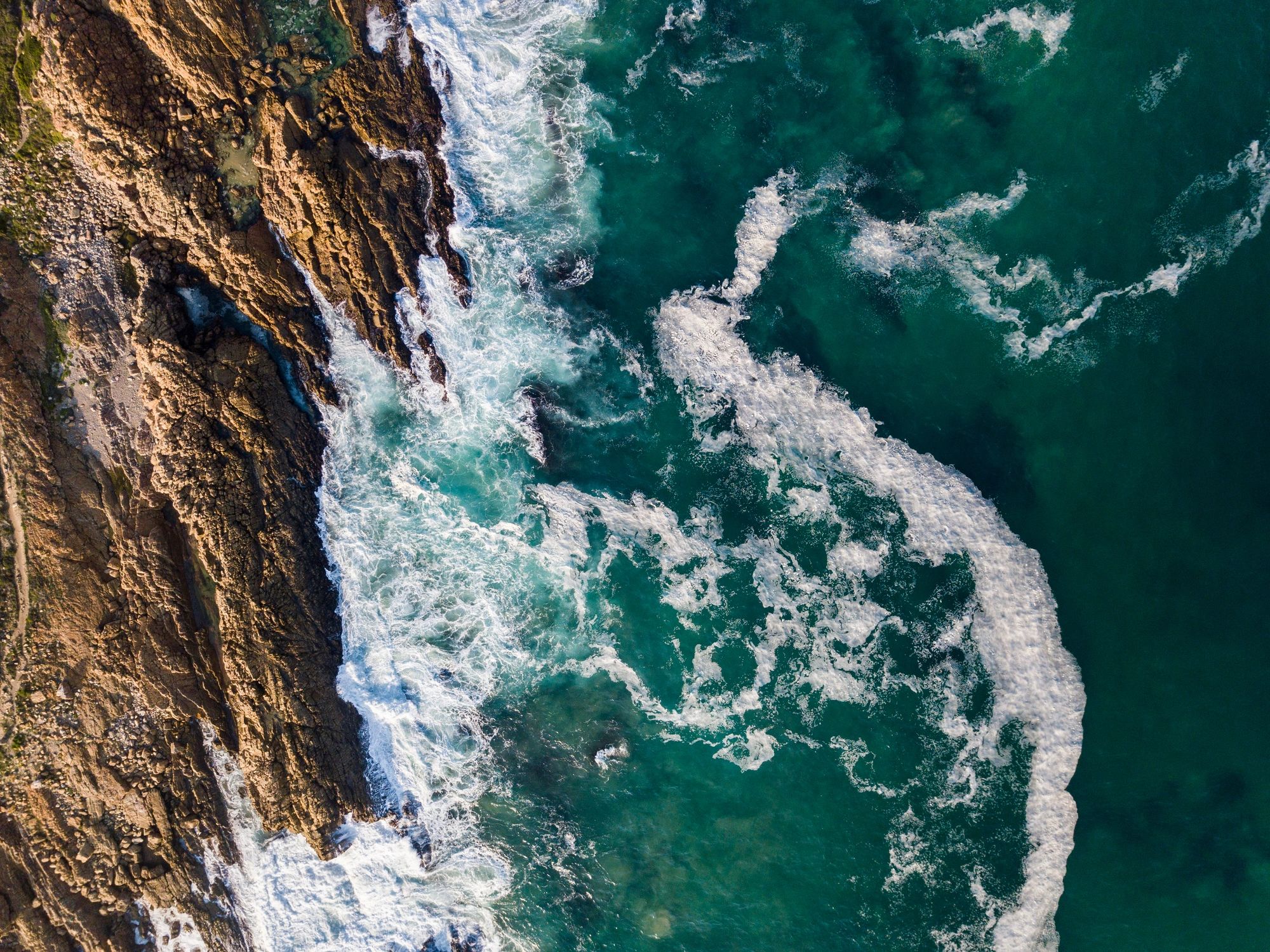 Aerial view of waves breaking on a rocky coastline