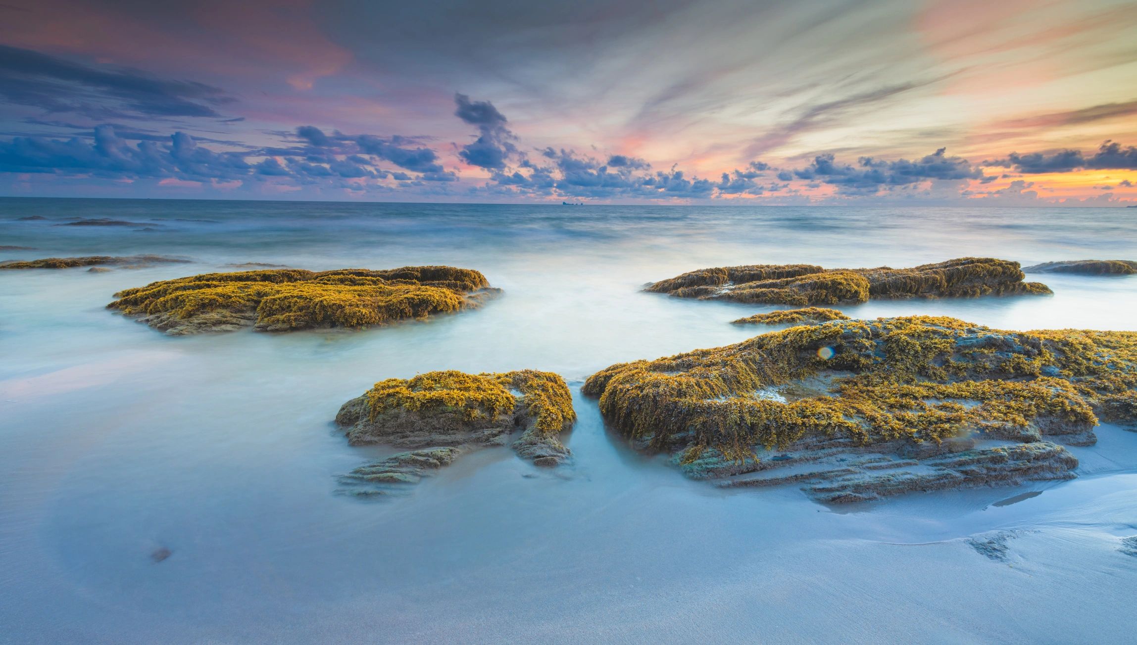 Sunset over a calm tropical shoreline
