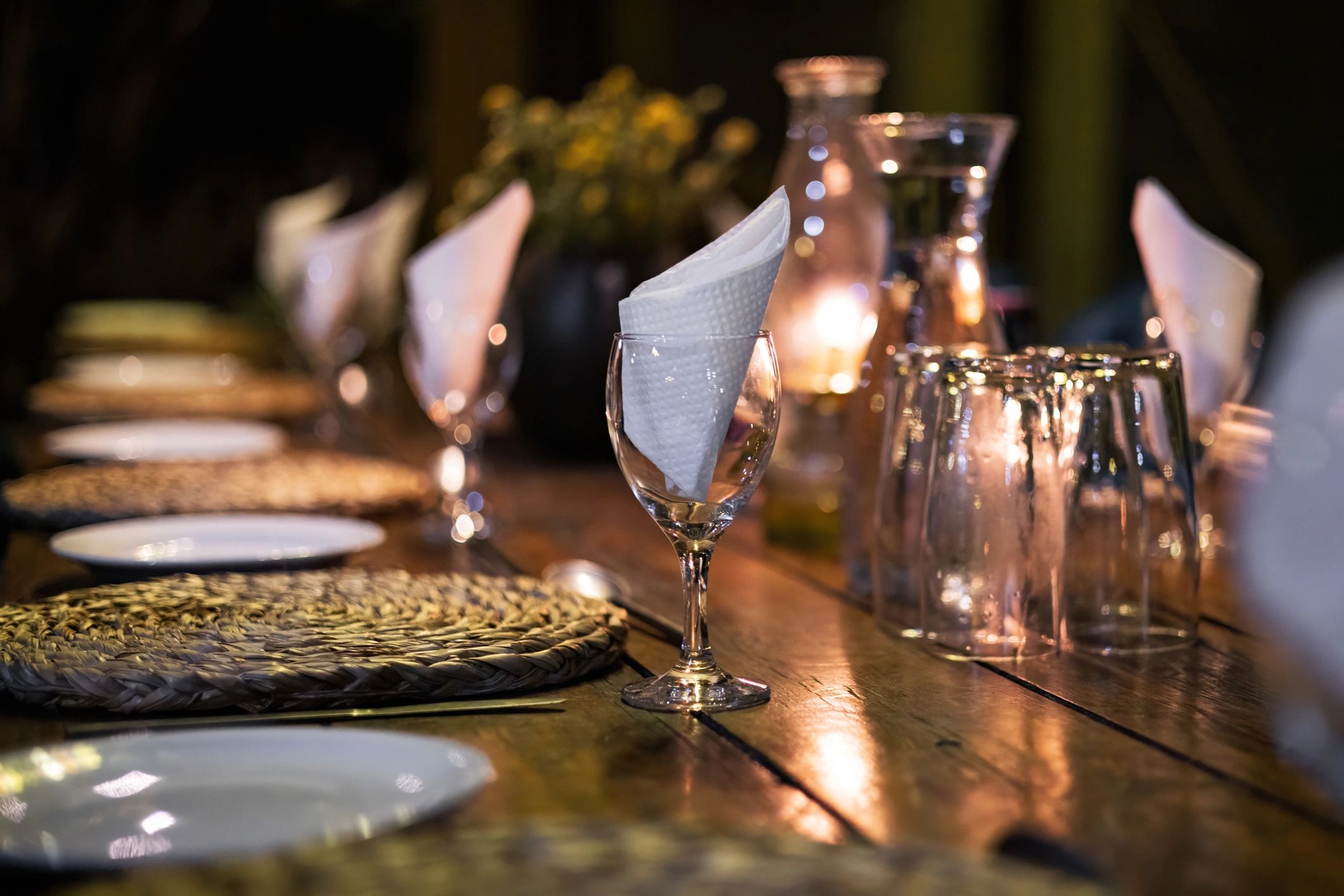 Outdoor dining table with candles and glassware