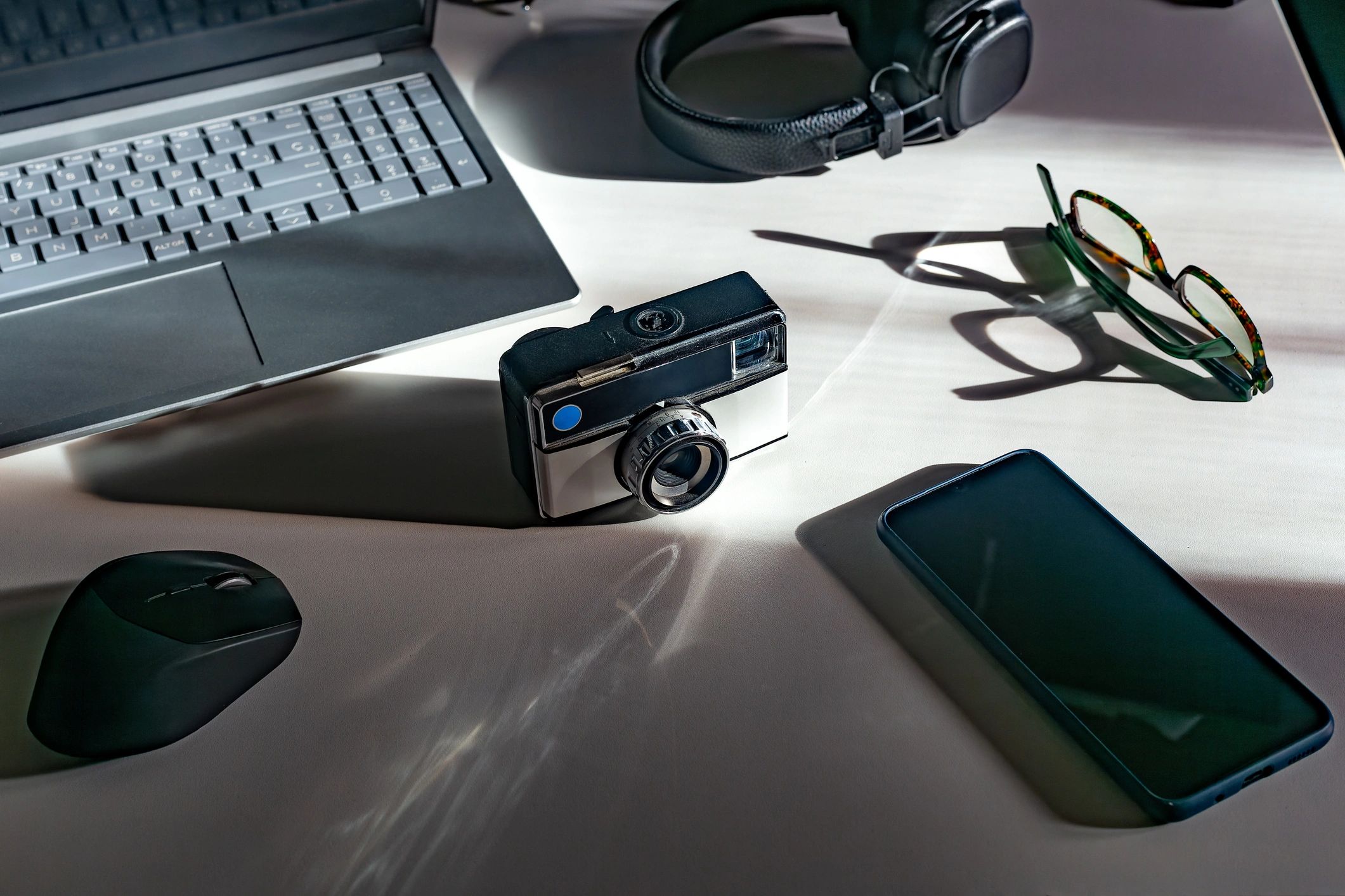 Minimal workspace with camera and creative tools
