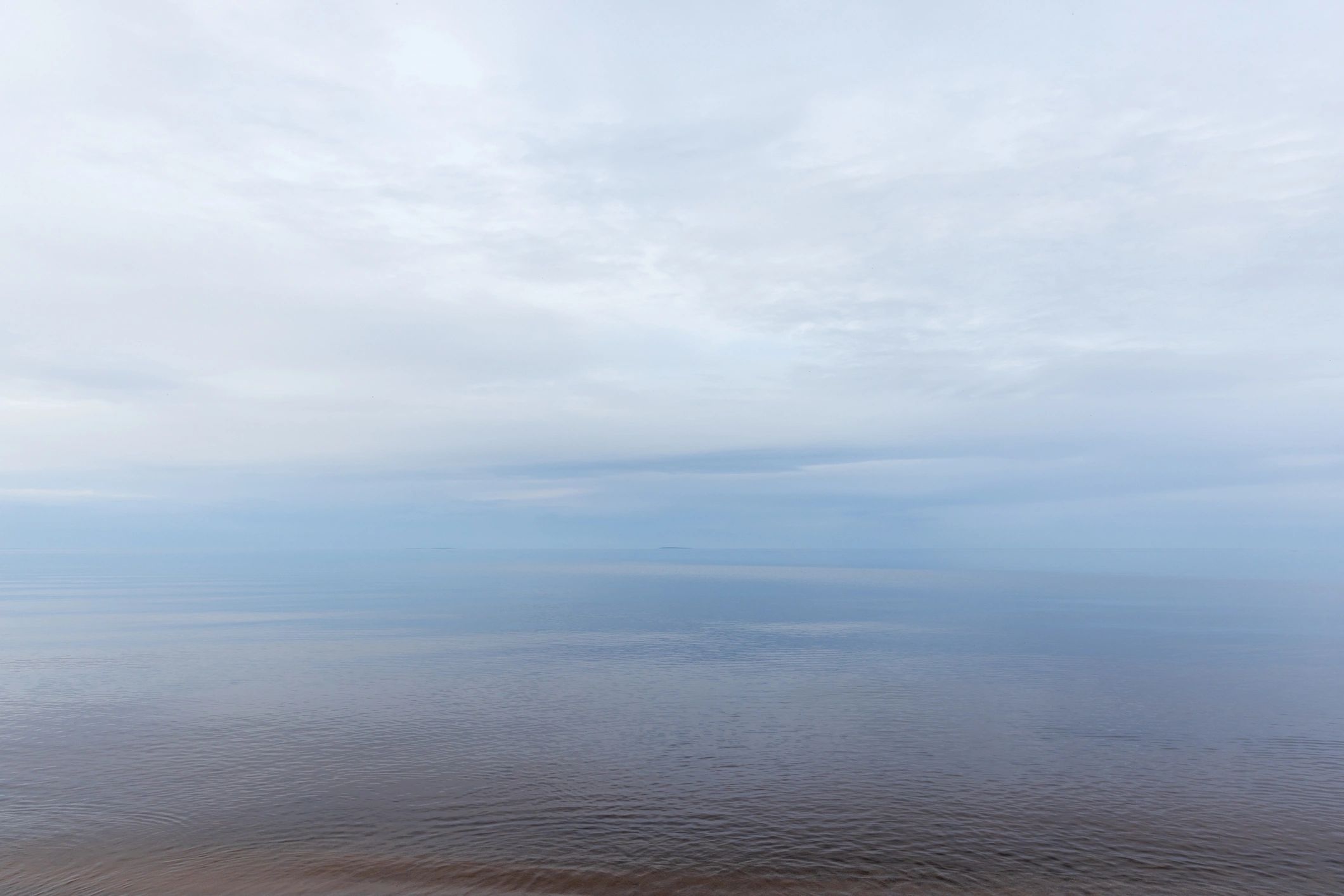 Minimalist lake horizon under an overcast sky