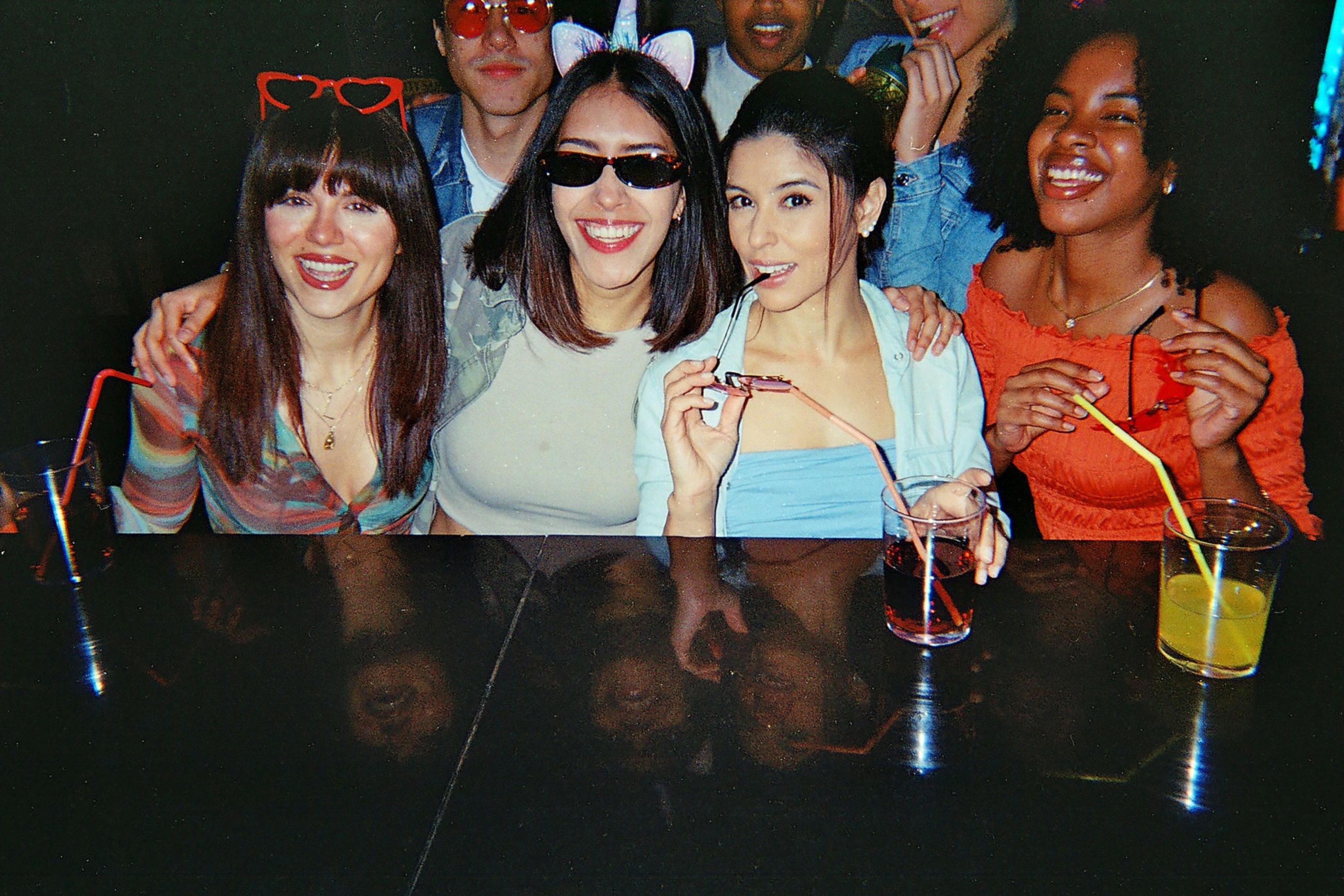 Friends enjoying drinks at a party captured on film